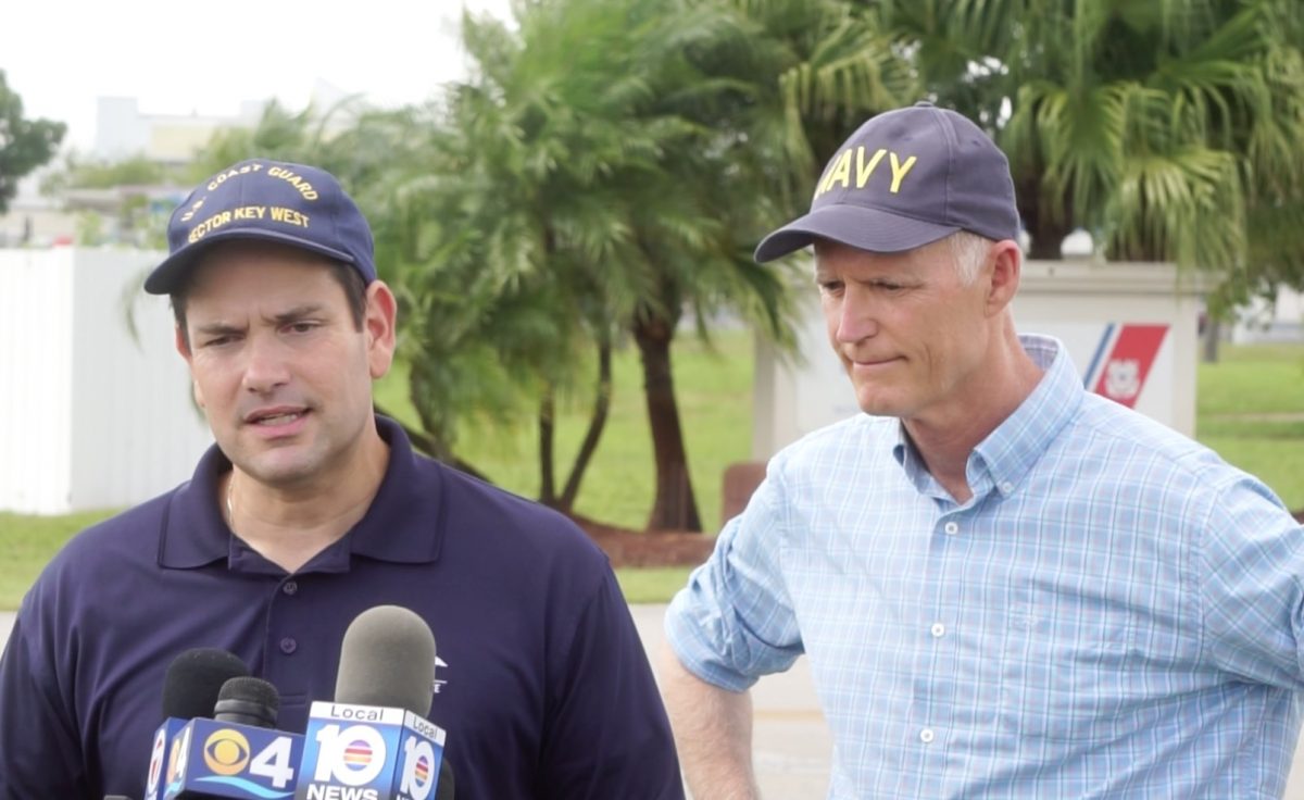 Sens. Marco Rubio and Rick Scott a the U.S. Coast Guard air station in Opa-Locka, Florida/ The Floridian